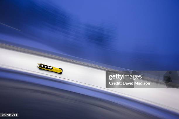 four-man bobsled on track. - bobsleigh team stock-fotos und bilder