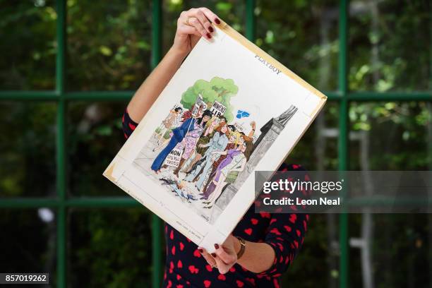 Auctioneer Catherine Southon poses with one of the hundreds of original works by Playboy cartoonist "Smilby" at a preview of two forthcoming sales of...