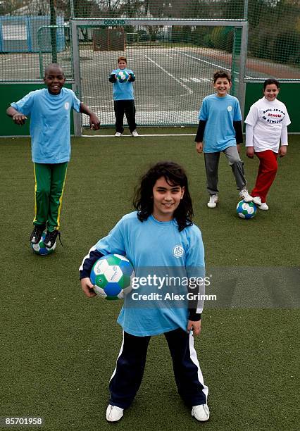 Pupils pose during a training session of a school soccer group on one of the DFB Mini Soccer Fields at the Anne Frank school on March 30, 2009 in...