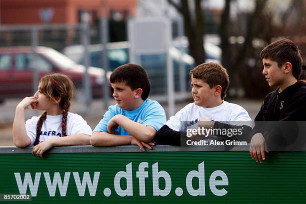 Pupils lean at the board during a training session of a school soccer group on one of the DFB Mini Soccer Fields at the Anne Frank school on March...