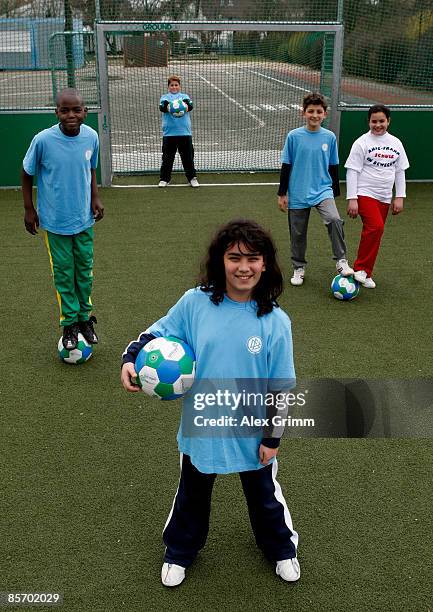 Pupils pose during a training session of a school soccer group on one of the DFB Mini Soccer Fields at the Anne Frank school on March 30, 2009 in...