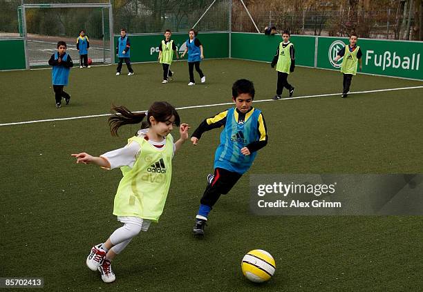 Pupils play soccer during a training session of a school soccer group on one of the DFB Mini Soccer Fields at the Anne Frank school on March 30, 2009...