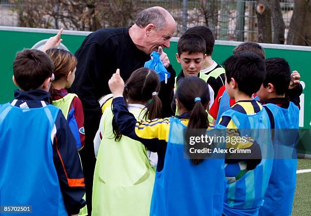 The coach talks to pupils during a training session of a school soccer group on one of the DFB Mini Soccer Fields at the Anne Frank school on March...