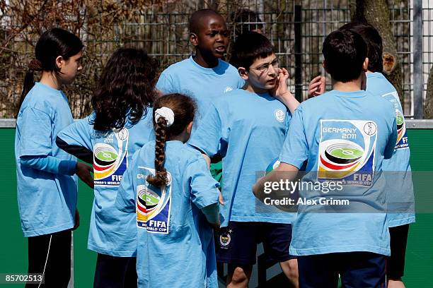 Pupils discuss during a training session of a school soccer group on one of the DFB Mini Soccer Fields at the Anne Frank school on March 30, 2009 in...