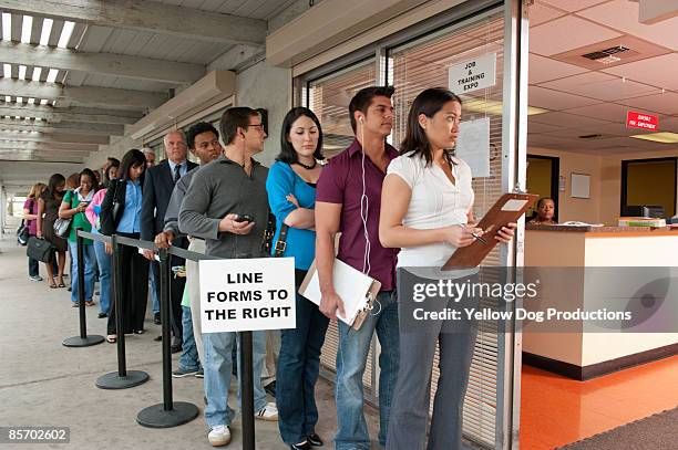 people standing in line at job and training fair - esperar na fila imagens e fotografias de stock