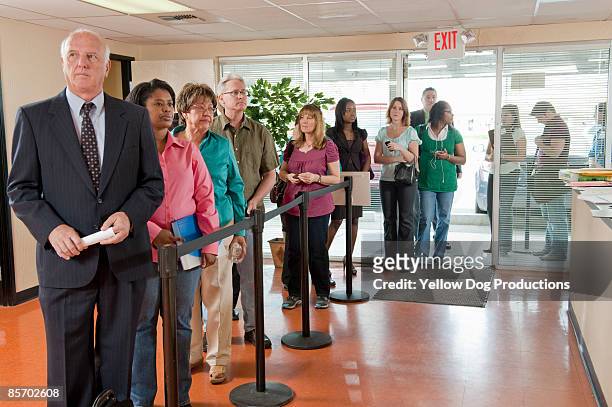 long line of people at unemployment office - unemployed stockfoto's en -beelden
