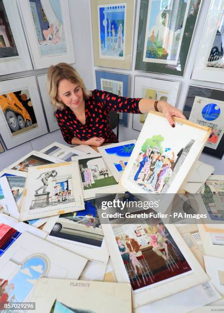 Auctioneer Catherine Southon holds examples from the Smilby cartoon collection, including works that appeared in Playboy, at the Ripley Arts Centre,...