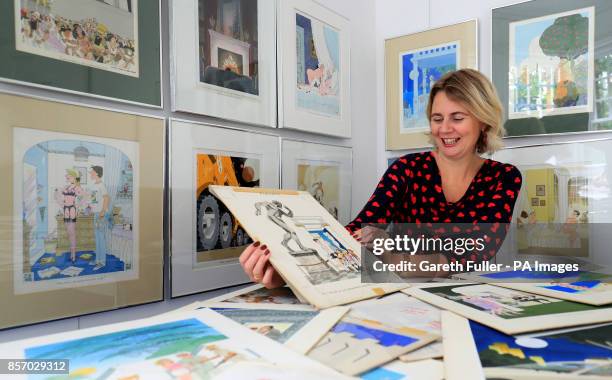 Auctioneer Catherine Southon holds examples from the Smilby cartoon collection, including works that appeared in Playboy, at the Ripley Arts Centre,...