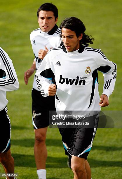 Dani Parejo and Javier Saviola of Real Madrid run during a training session on March 30, 2009 in Madrid, Spain.