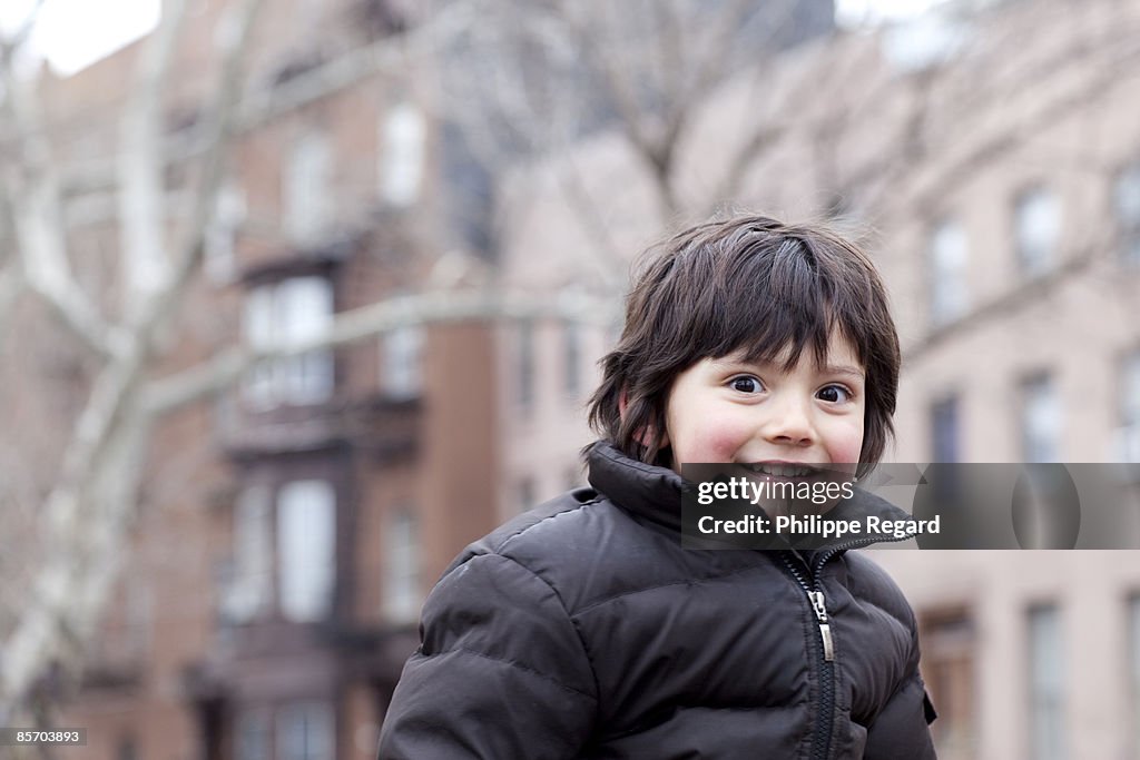 Cute 3 years old boy smiling at camera.