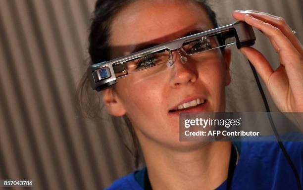 Woman wears a pair of smart glasses using 'Open Access Smart Capture technology' which enables hearing impaired theatre-goers to see subtitles in...