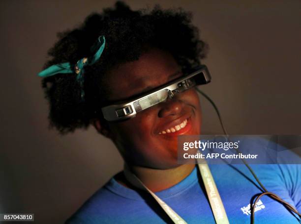 Woman wears a pair of smart glasses using 'Open Access Smart Capture technology' which enables hearing impaired theatre-goers to see subtitles in...