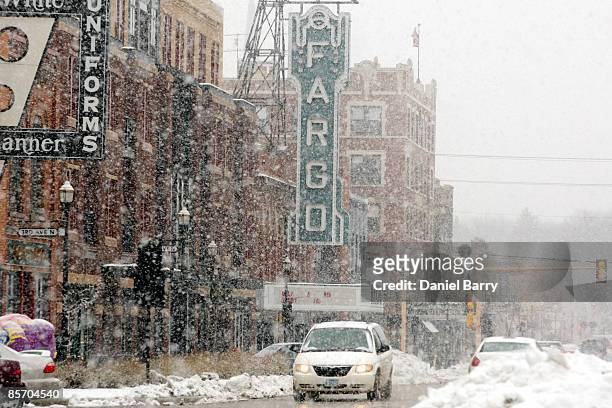Snow begins to fall March 30,2009 in downtown Fargo, North Dakota. Fargo and the surrounding area are expecting a storm Monday that could bring up to...