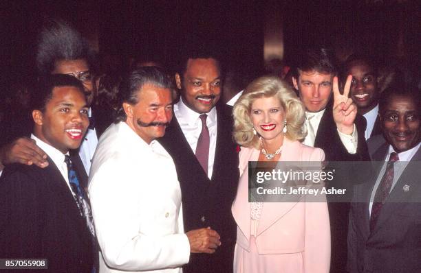 Jesse Jackson Jr with Don King Artist Leroy Nieman, Reverend Jesse Jackson Sr, Ivana Trump and Businessman Donald Trump flashing the victory sign,...