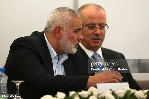 Hamas's overall leader Ismail Haniya and Palestinian prime minister Rami Hamdallah are seen together at Haniya's office in Gaza City on October 3,...