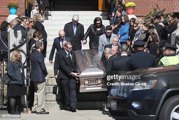 Angela Masucci, right rear following casket, files out of the Sacred ...