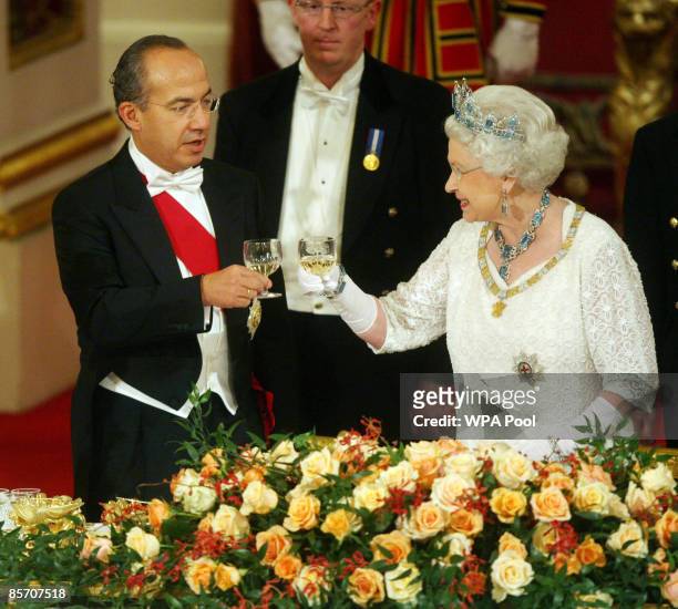 Queen Elizabeth II and Mexico's President Felipe Calderon toast their glasses during a state banquet hosted by the Queen in honour of the visiting...