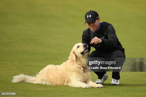 Matthew Fitzpatrick of England plays with his family dog, Charlie, during practice prior to the 2017 Alfred Dunhill Links Championship at Kingsbarns...