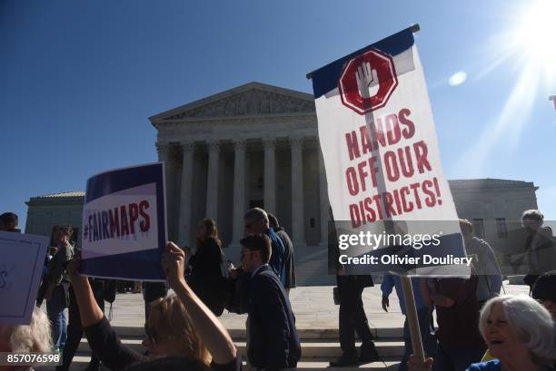 Demonstrators gather outside of The United States Supreme Court during an oral arguments in Gill v. Whitford to call for an end to partisan...