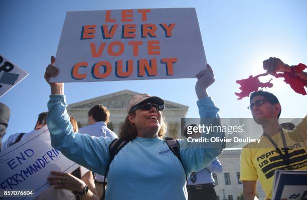 Demonstrators gather outside of The United States Supreme Court during an oral arguments in Gill v. Whitford to call for an end to partisan...