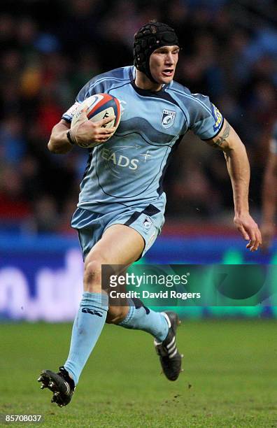 Tom James of Cardiff runs with the ball during the EDF Energy Cup Semi Final between Cardiff Blues and Northampton Saints at the Ricoh Arena on March...