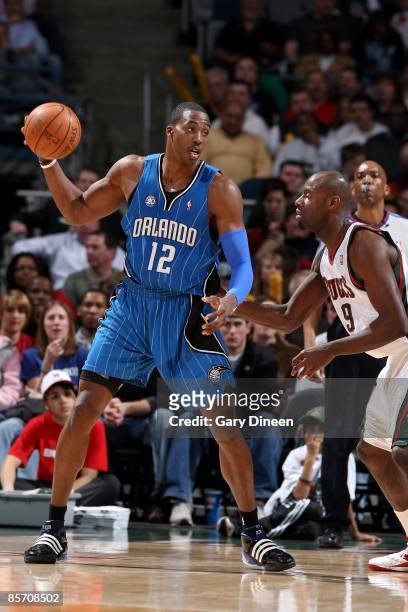 Dwight Howard of the Orlando Magic looks to pass against Francisco Elson of the Milwaukee Bucks during the game on March 18, 2009 at the Bradley...