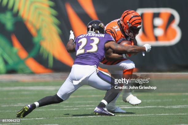 Jeremy Hill of the Cincinnati Bengals runs the football upfield against Tony Jefferson of the Baltimore Ravens during their game at Paul Brown...
