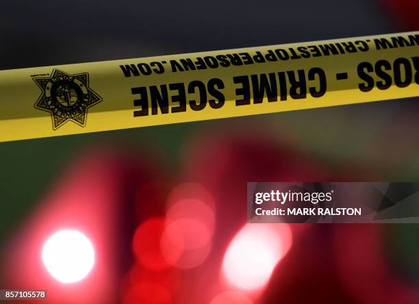 Crime scene tape and red balloons outside the Route 91 festival venue on October 3, 2017 after a gunman killed more than 59 people and wounded more...