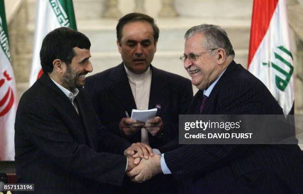 Iranian President Mahmoud Ahmadinejad shakes hands with his Iraqi counterpart Jalal Talabani during a press conference at his Baghdad residence on...