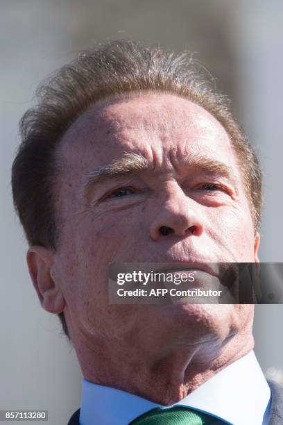 Former California Governor and actor Arnold Schwarzenegger speaks outside the US Supreme Court in Washington, DC, October 3 after the court heard...