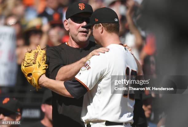 Matt Cain of the San Francisco Giants hugs manager Bruce Bochy as Bochy was taking Cain out of the game after the top of the fourth inning against...