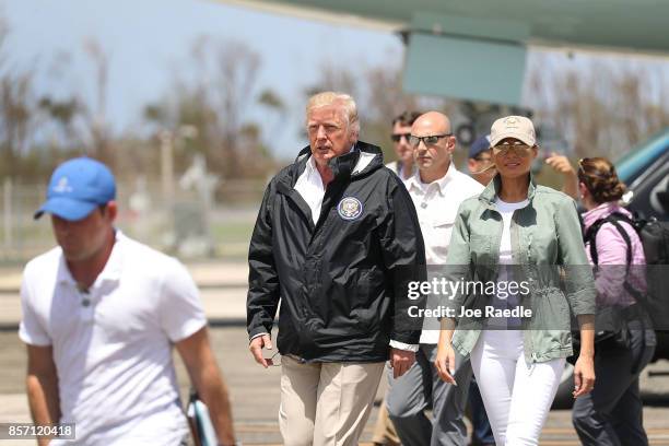 President Donald Trump and Melania Trump arrive on Air Force One at the Muniz Air National Guard Base for a visit after Hurricane Maria hit the...