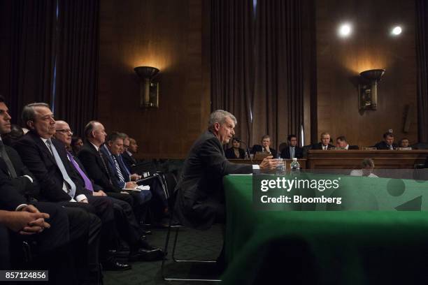 Tim Sloan, chief executive officer and president of Wells Fargo & Co., center, speaks during a Senate Banking, Housing and Urban Affairs Committee...