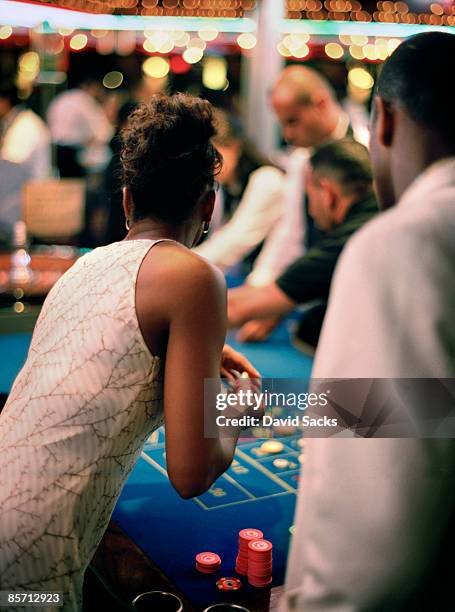 couple at roulette table - roulette stock pictures, royalty-free photos & images