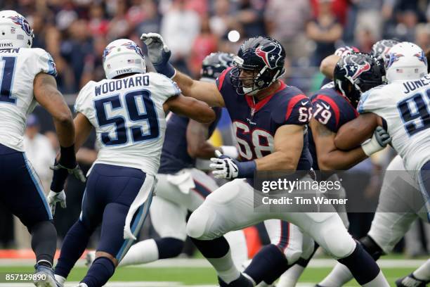 Breno Giacomini of the Houston Texans blocks Wesley Woodyard of the Tennessee Titans in the first half at NRG Stadium on October 1, 2017 in Houston,...