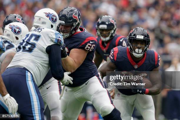 Lamar Miller of the Houston Texans runs the ball as Nick Martin blocks Sylvester Williams of the Tennessee Titans in the second half at NRG Stadium...