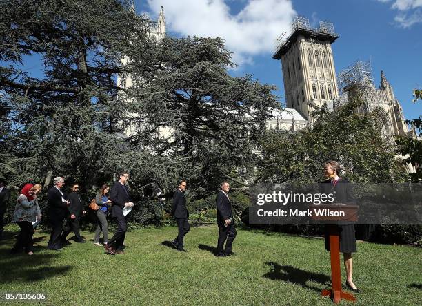 Rev. Mariann Budde, Bishop of the Episcopal Diocese of Washington walks up to speak while flanked by a group of local religious leaders from many...