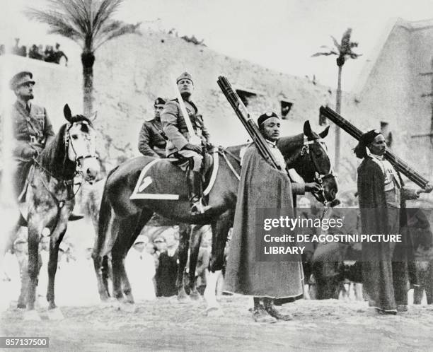 Benito Mussolini on horseback holding the sword of Islam in Tripoli, with Italo Balbo on the left, Libya, from L'Illustrazione Italiana, March 28,...