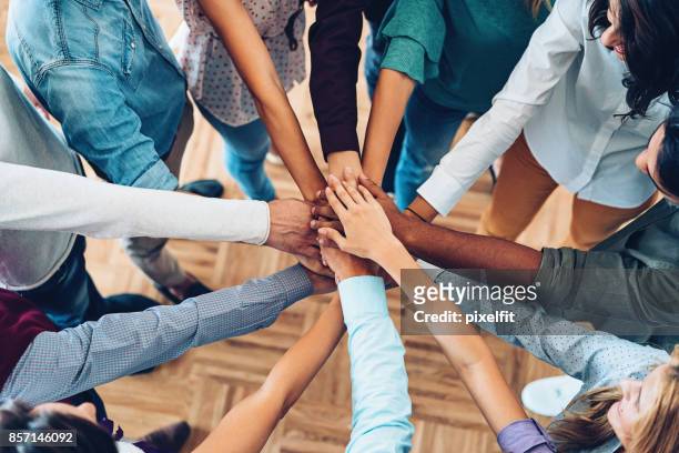 sea of hands - employee engagement stock pictures, royalty-free photos & images