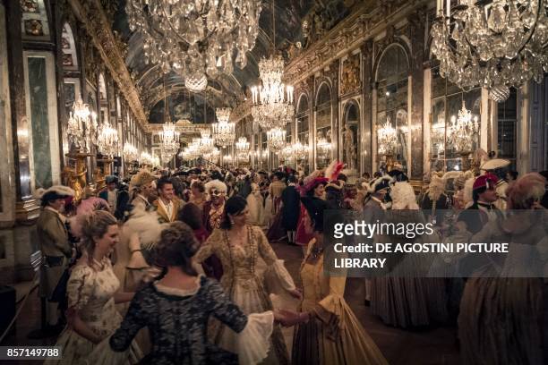 Grand ball in the Hall of Mirrors, courtship party with participants wearing clothes from the Louis XIV period, Palace of Versailles, France....