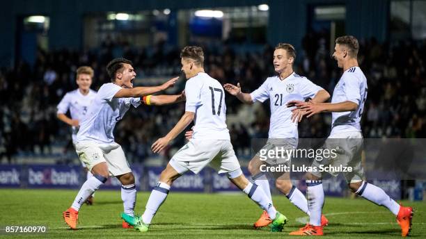 Scorer Timon Burmeister celebrates his teams first goal with Marvin Obuz , Albin Thaqi and Sebastian Papalia of Germany during the friendly match...