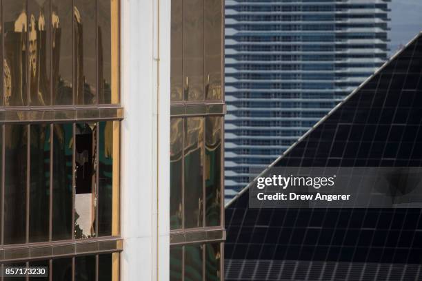 Window is broken on the 32nd floor of the Mandalay Bay Resort and Casino where a gunman opened fire on a concert crowd during a mass shooting at the...