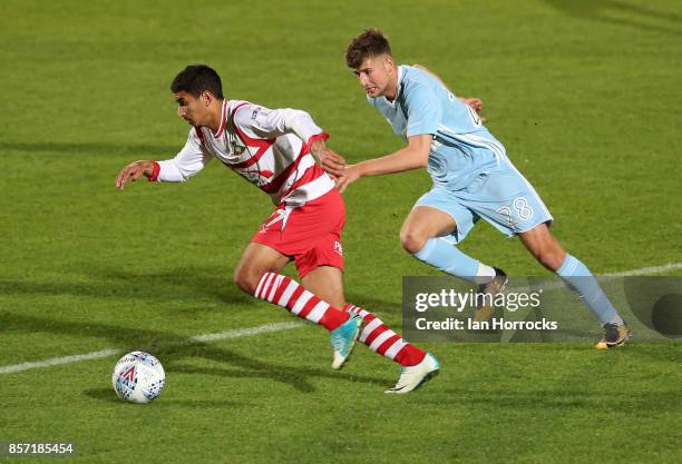 Ethan Robson of Sunderland chases Issam Ben Khemis of Doncaster during the Checkertrade Trophy match between Doncaster Rovers and Sunderland U21 at...