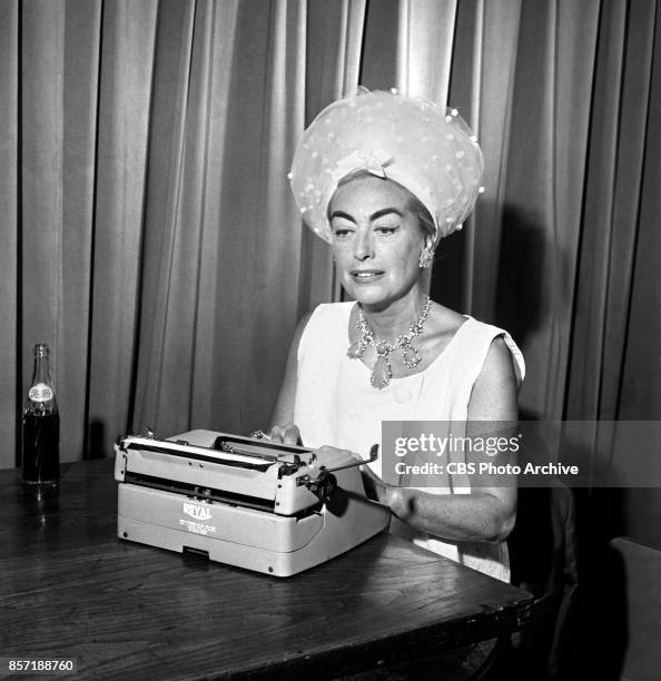 Movie actress Joan Crawford seated at a typewriter. She prepares to be a judge for the Miss America Pageant, broadcast on CBS, September 9, 1961....