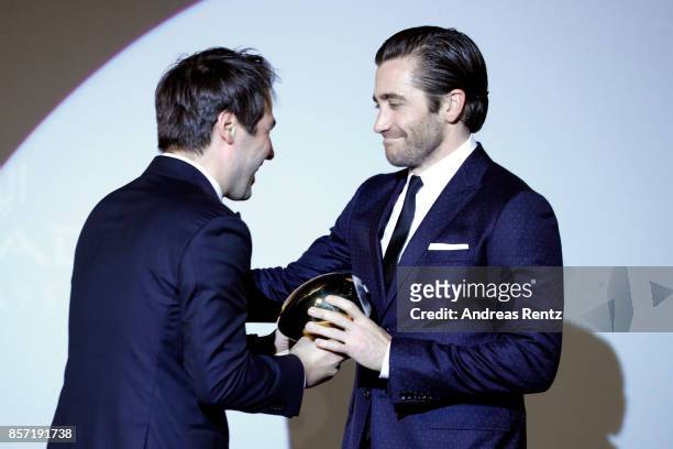 Festival director Karl Spoerri hands over the Golden Eye Award to Jake Gyllenhaal at the 'Stronger' premiere at the 13th Zurich Film Festival on...