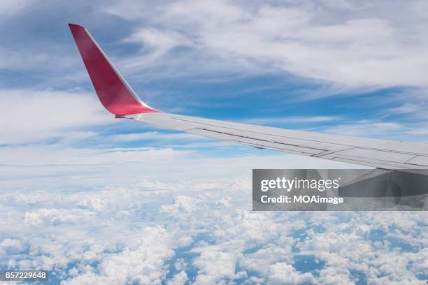 overlooking the scenery through the window on the plane - aircraft wing stock pictures, royalty-free photos & images