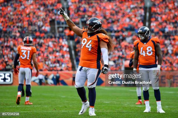 Nose tackle Domata Peko of the Denver Broncos works to get the crowd to get loud in the fourth quarter of a game against the Oakland Raiders at...