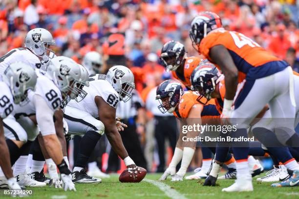 The Oakland Raiders line up on offense behind Rodney Hudson in the third quarter of a game against the Denver Broncos at Sports Authority Field at...