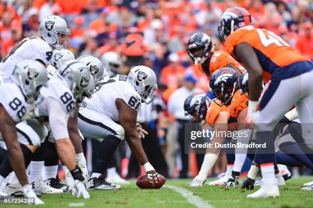 The Oakland Raiders line up on offense behind Rodney Hudson in the third quarter of a game against the Denver Broncos at Sports Authority Field at...