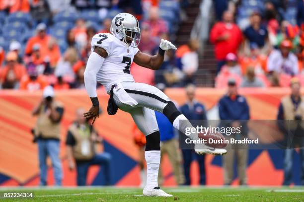 Punter Marquette King of the Oakland Raiders punts against the Denver Broncos in the third quarter of a game at Sports Authority Field at Mile High...